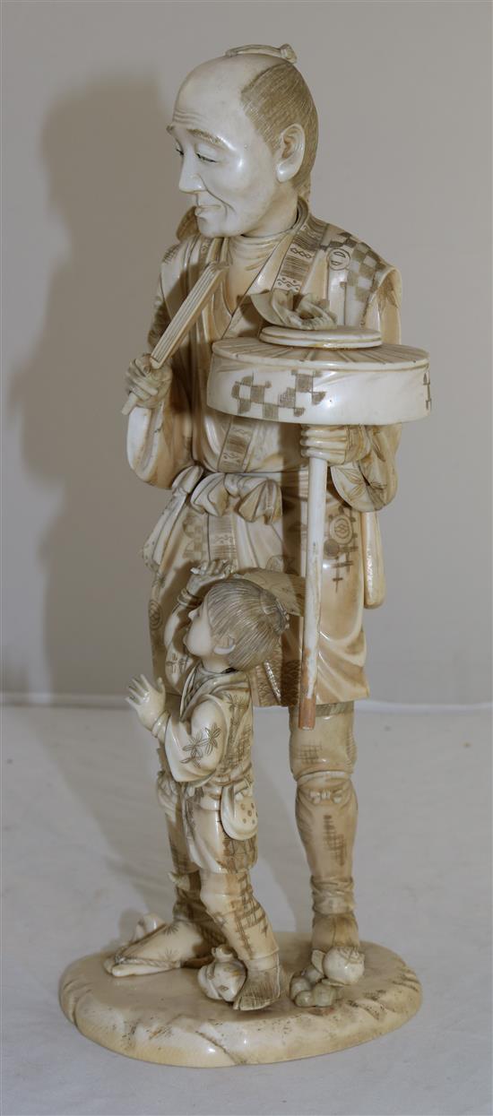 A large sectional ivory group of man and a boy, early 20th century, 30.5cm